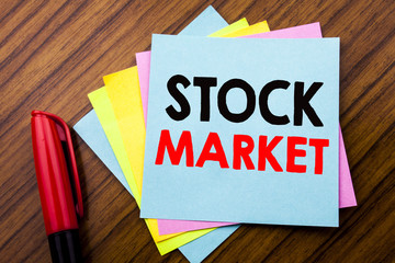 Handwriting Announcement text Stock Market.  Concept for Equity Share Exchange Written on sticky stick note paper with wooden background with space office view with pencil marker