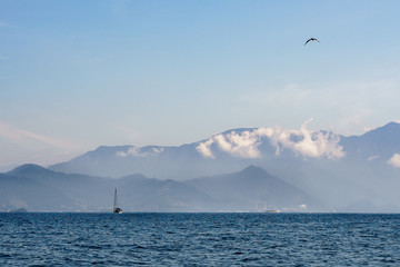 sea view with saling boat and the mountains on the backgroung