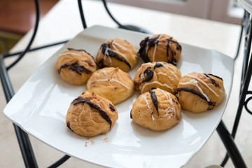 Eclair or Choux Cream with topped chocolate on white plant