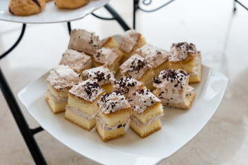 Layer cake bake cream with chocolate on white plate