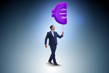 Businessman walking with inflatable euro sign