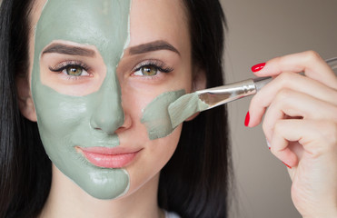 girl in a mask of green clay