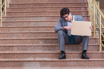 Desperate businessman begging on the street