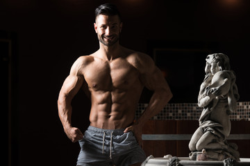 Fototapeta na wymiar Man in Sauna Showing His Well Trained Body