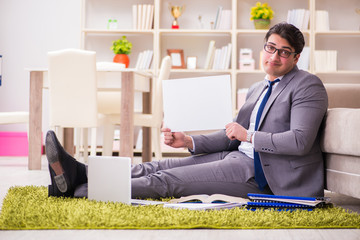 Businessman working on the floor at home