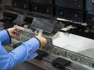 operator bending metal sheet by sheet bending machine