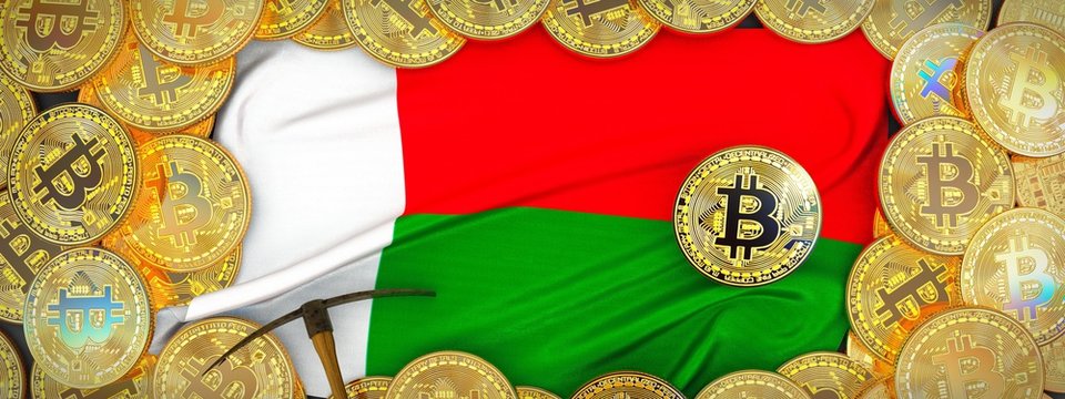Bitcoins Gold around Madagascar flag and pickaxe on the left.3D Illustration.