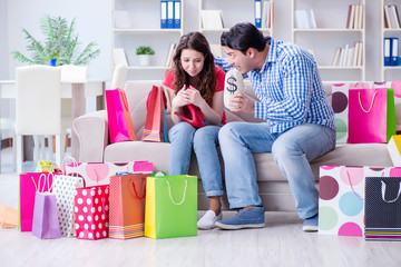 Young pair after shopping with many bags