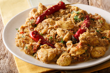 Indian spicy chettinad chicken curry with chili pepper closeup on a table. horizontal