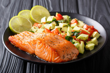 Organic food: baked wild salmon steak and fresh vegetable salad closeup. horizontal
