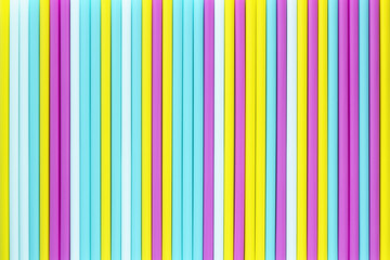 Abstract background of colorful cocktail tubes. Close-up top view image. Colored plastic drinking straws texture.
