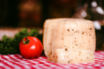 Rustic cheese with herbs and tomatoes