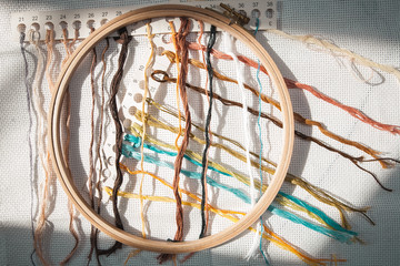 Beautiful embroidery threads on a canvas with a hoop a magnificent background for a hobby
