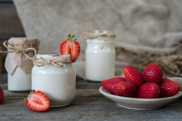 Organic yougurt in jar with strawberry. Fresh strawberry with yogurt