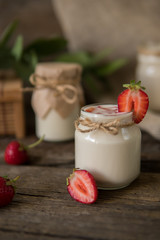 Organic yougurt in jar with strawberry. Fresh strawberry with yogurt