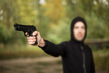 A man holding a gun in hand, the ship ready to shoot the man pointed a gun at us. A man holding a gun was robbed.