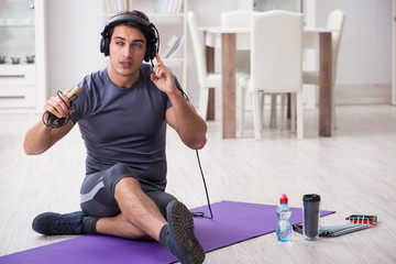 Man doing sports at home and listening to music