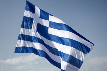 A gigantic Greek flag hangs from a crane in Syntagma square, Athens, Greece.