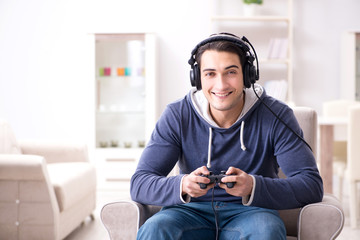 Young man playing computer games at home