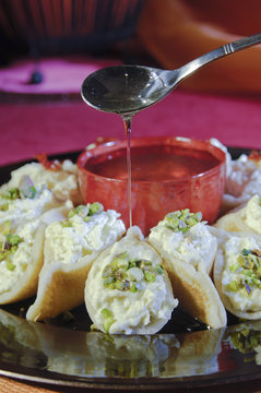 Pouring Syrup on Asafeer, Arabic Sweets for Ramadan and Eid