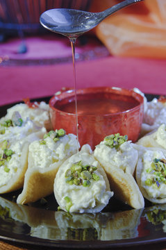 Pouring Syrup on Asafeer, Arabic Sweets for Ramadan and Eid