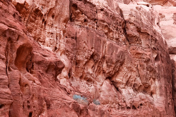 Red stone walls of the canyon in desert.