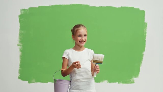 Girl child near green screen wall