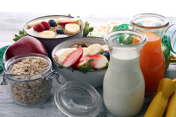 muesli with dairy and fruit, healthy lifestyle. bowl of cereal, fruit and dumbbell