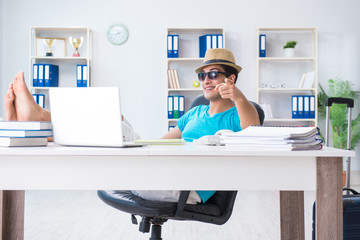 Businessman preparing for vacation in the office
