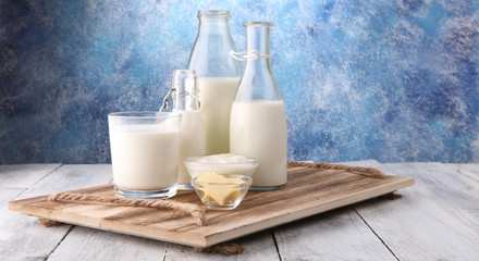 milk products. tasty healthy dairy products on a table on. sour cream in a bowl, cottage cheese bowl, cream in a a bank and milk jar, glass bottle and in a glass