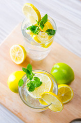 Glasss of mojito with lemon and drinking straw