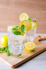 Glasss of mojito with lemon and drinking straw