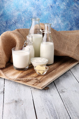 milk products. tasty healthy dairy products on a table on. sour cream in a bowl, cottage cheese bowl, cream in a a bank and milk jar, glass bottle and in a glass