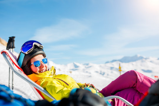 Picture of smiling sports woman lying on deckchair