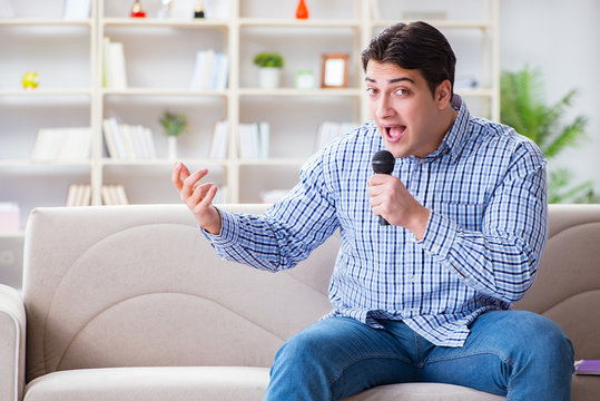 Funny man singing songs in karaoke at home