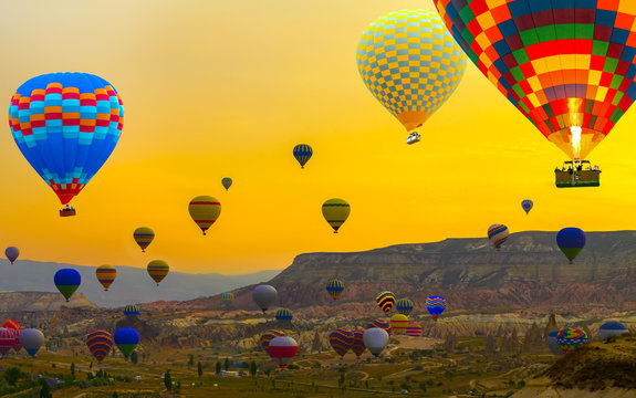 Sunset Hot air balloons landing in a mountain Cappadocia Goreme National Park Turkey tourist attraction