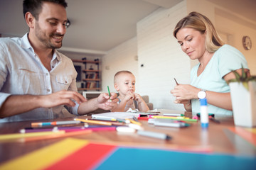 Parents with a son drawing and color