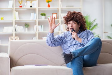 Funny man singing songs in karaoke at home