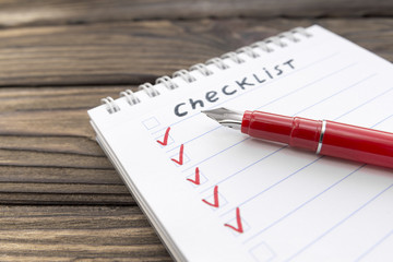 checklist, pen on a wooden background. business. finance. planning.