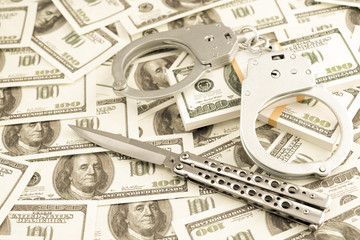 knife, handcuffs, dollars. robbery. violation of criminal law