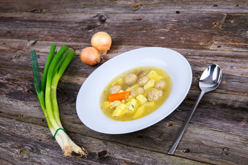 marrow balls soup in white plate with onion