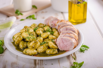 Pork tenderloin with herbs and spices, pesto gnocchi