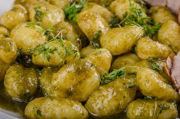 Pork tenderloin with herbs and spices, pesto gnocchi