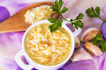 noodle soup and chicken with carrot and garlic