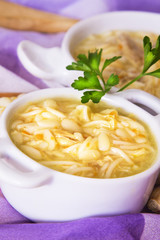 noodle soup and chicken with carrot and garlic