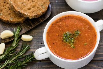 Thick Italian soup minestrone on a wooden table