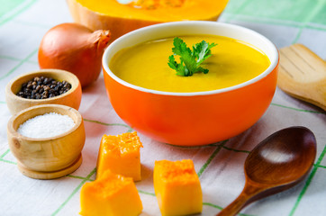 Pumpkin soup served on the table in bowl