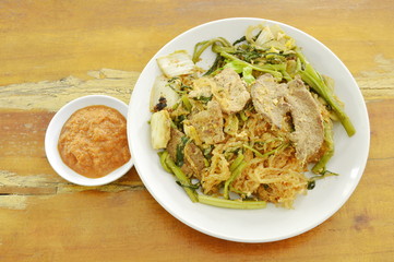 fried glass noodles with pork and vegetable on plate dipping sukiyaki sauce