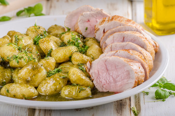 Pork tenderloin with herbs and spices, pesto gnocchi