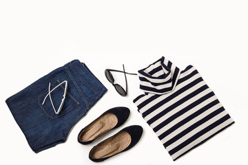 Fashion set of blue jeans, striped sweater, shoes and sunglsses on white background.